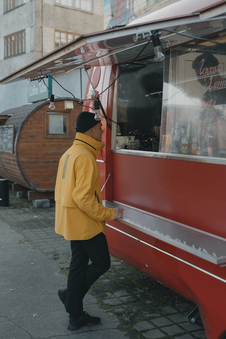 A Man Buying From A Food Truck