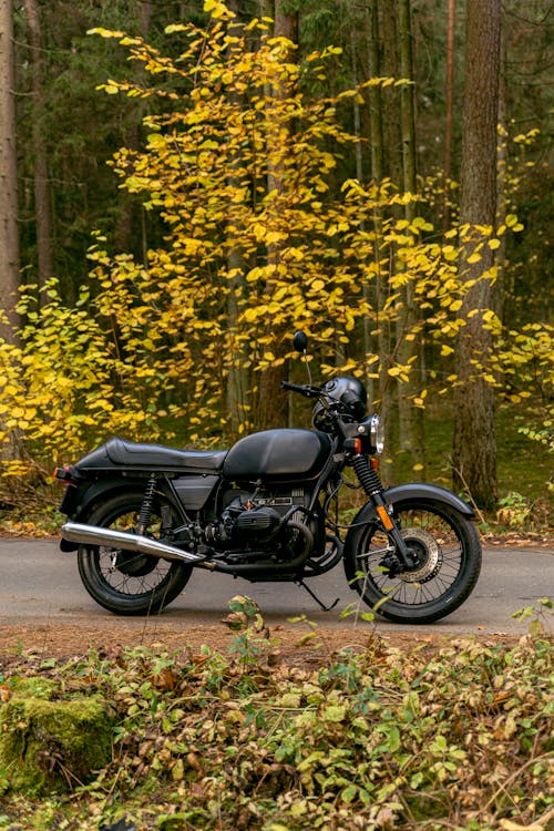 A Black Motorcycle Parked on the Side of a Road