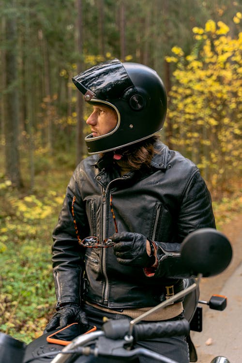 Free A Man Sitting on His Parked Motorcycle Stock Photo