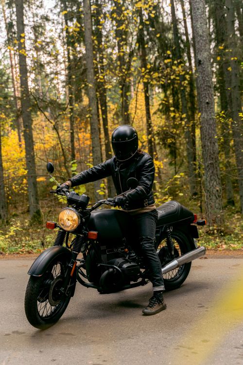 Homem com estilo motociclista usando jaqueta de couro e jeans