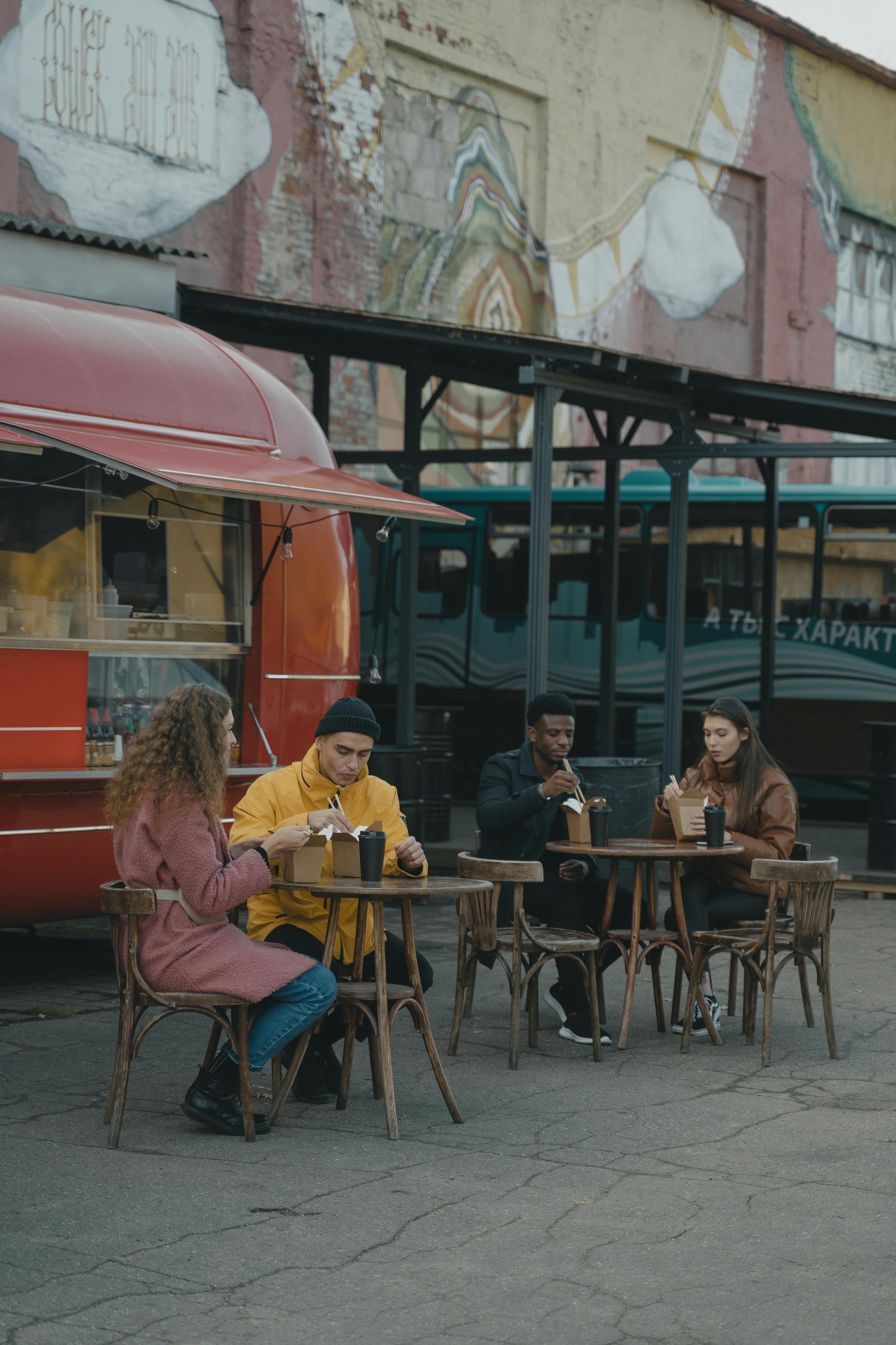 people eating in an outdoor setting of a food truck