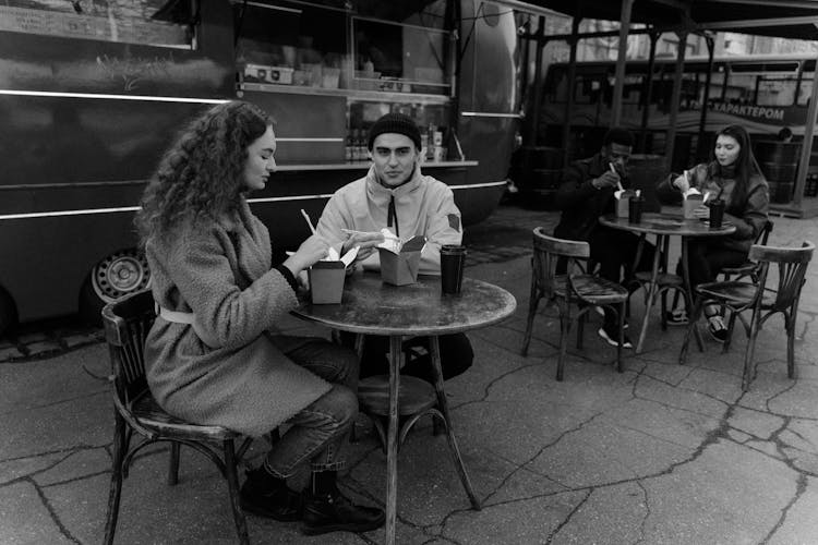 Couples Dining Near A Food Truck