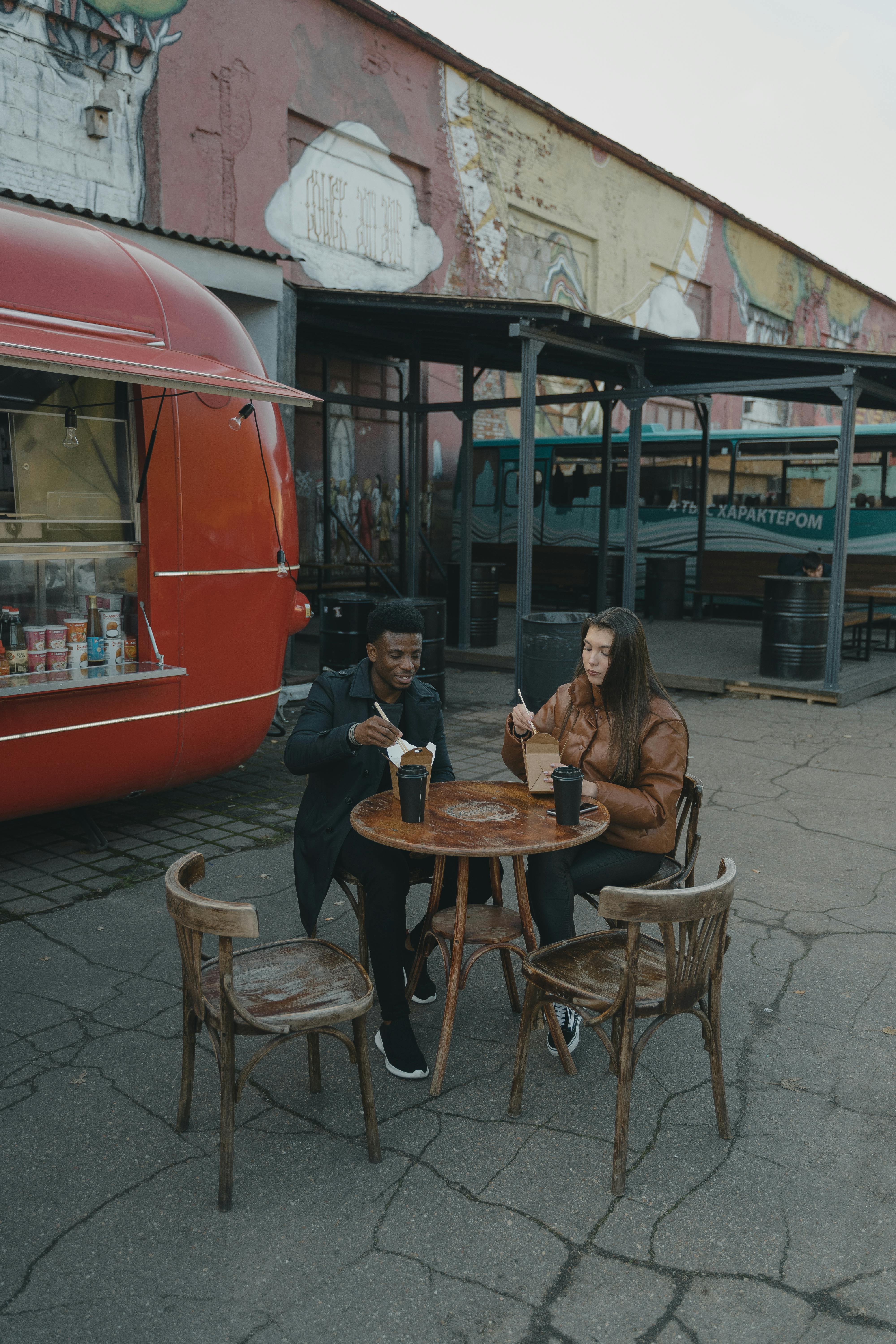 a couple eating in an outdoor setting