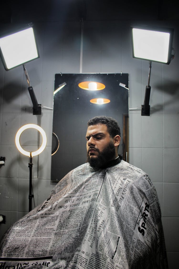 A Man Drape With A Barber Cape