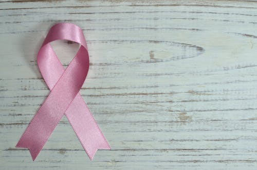 Free Breast Cancer Awareness on Teal Wooden Surface Stock Photo