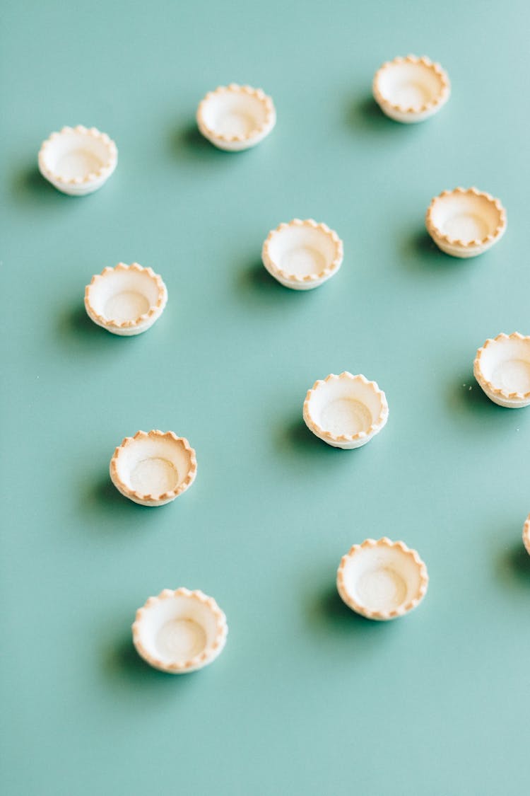 Mini Tart Shells On Green Background