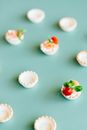 Sliced Cherry Tomatoes and Herbs as Garnish on Mini Tarts