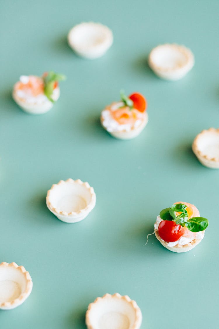 Sliced Cherry Tomatoes And Herbs As Garnish On Mini Tarts