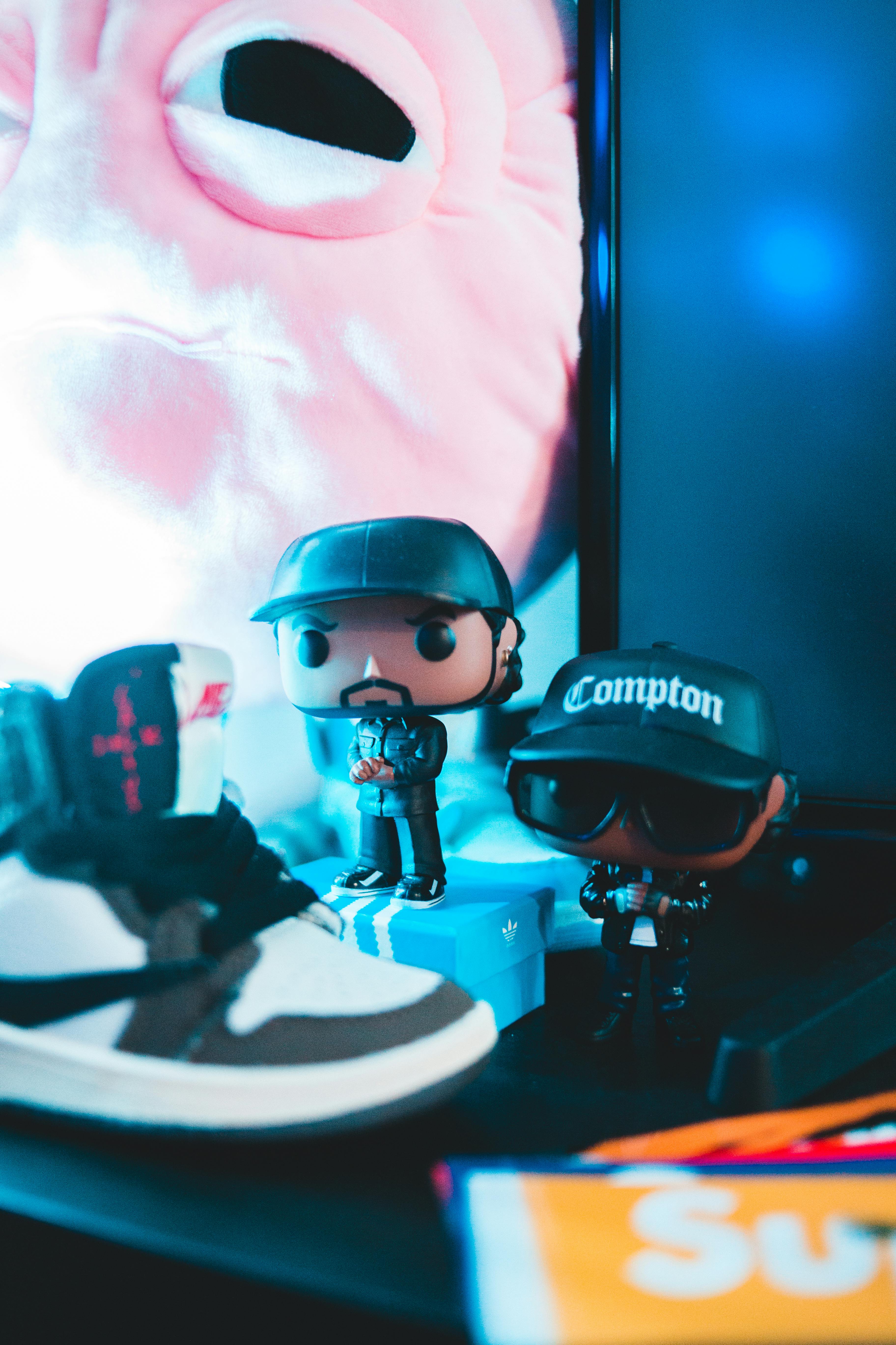 Collectible figures of rap artist on shelf · Free Stock Photo