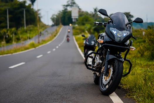 Black motorbike parked on a scenic open road, perfect for adventure enthusiasts.