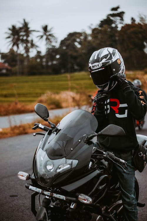 A Person in a Helmet Riding a Motorcycle