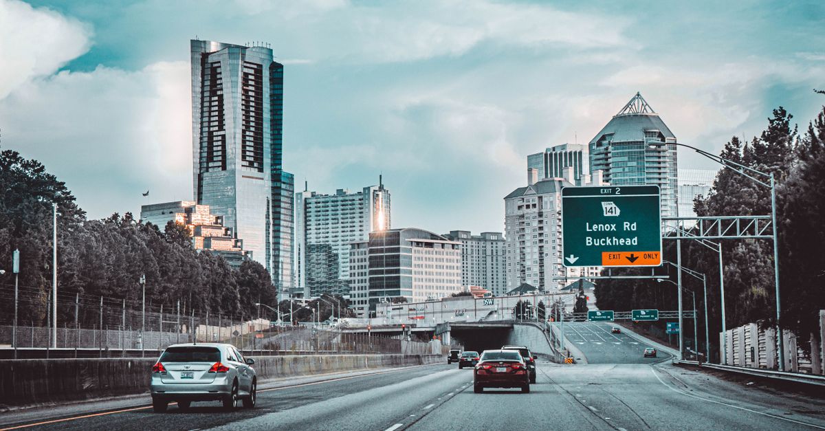 Scenic view of Buckhead skyline in Atlanta, Georgia. Cars on expressway under cloudy sky.