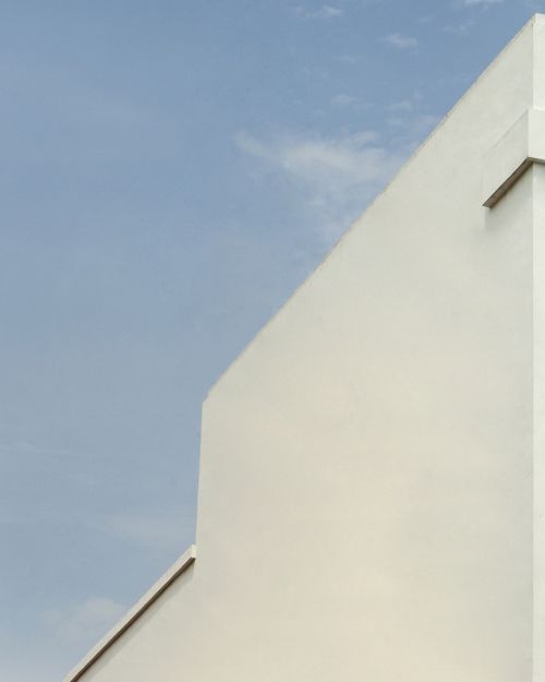 Free A sleek concrete building facade set against a clear blue sky in Jogja, Indonesia. Stock Photo