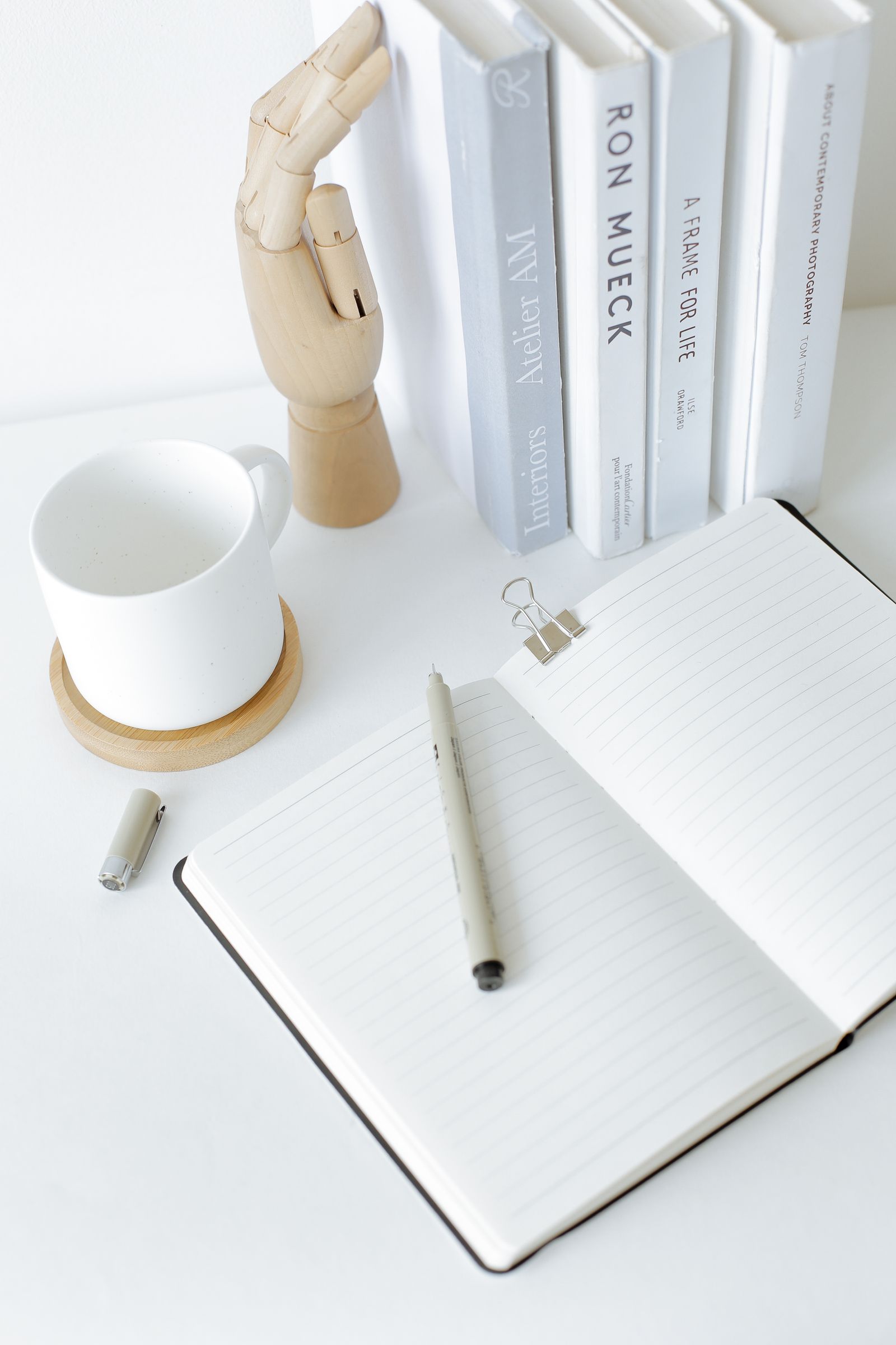 An open notebook and books used to turn reading into connected notes