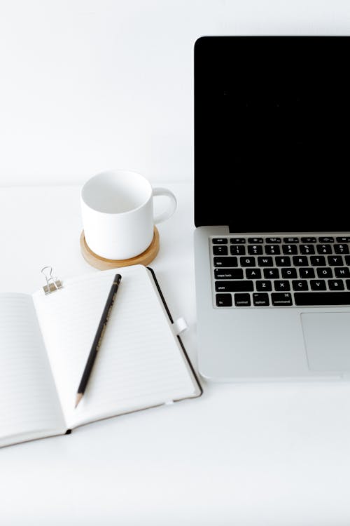 Free Workplace with laptop and opened diary Stock Photo