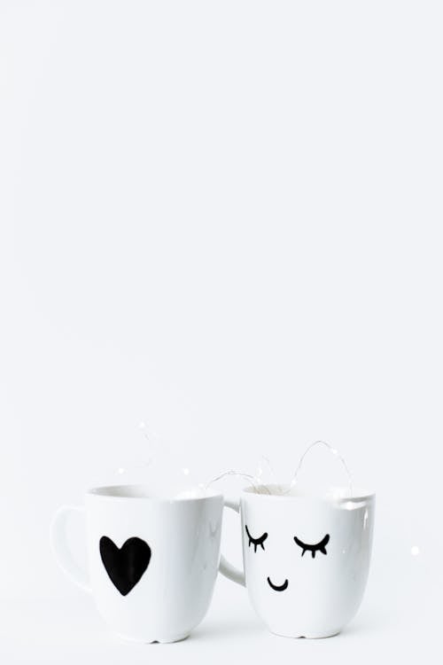 Creative white mugs on white surface