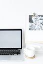 Modern opened laptop on desk near cup