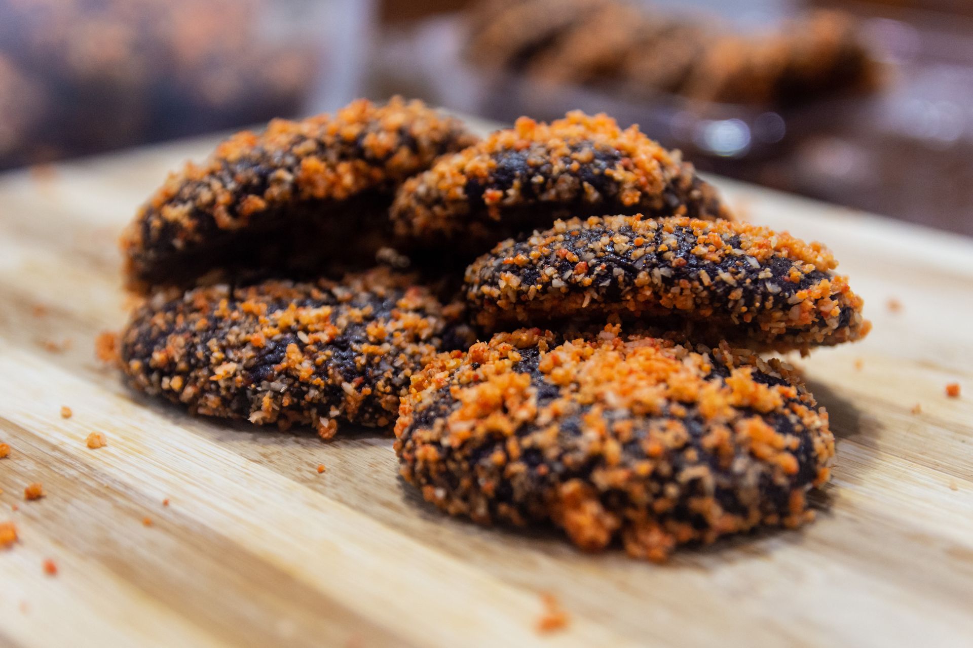 Delicious crumbly butternut cookies with crunchy topping on a wooden surface.