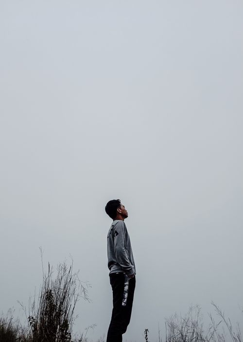 A Man in Black T-shirt and Cap Standing on Grass · Free Stock Photo