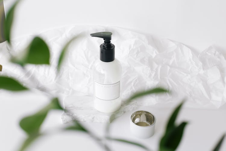 Bottle Of Nourishing Cream On White Table