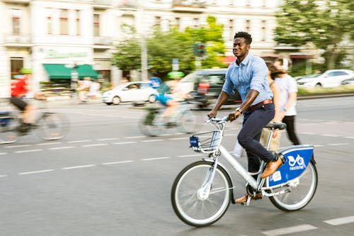 Free A Man in Casual Wear Biking in the City  Stock Photo
