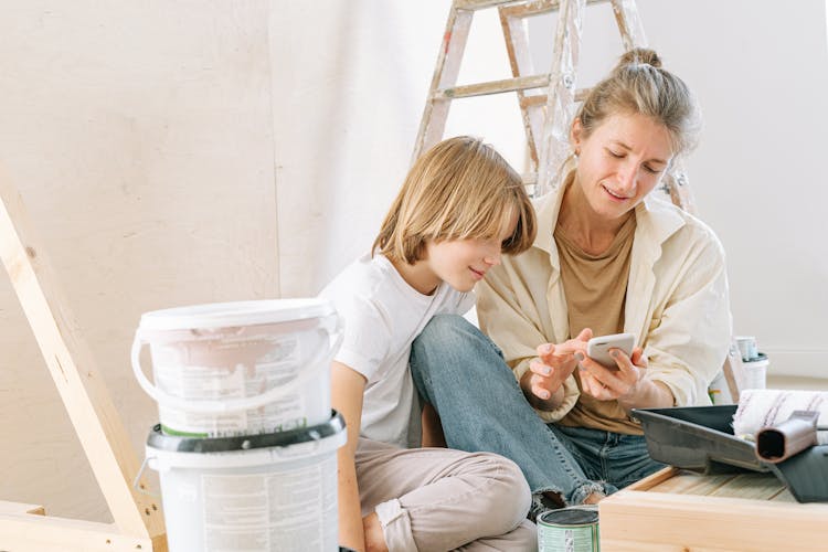 Mother And Son Looking At The Smartphone