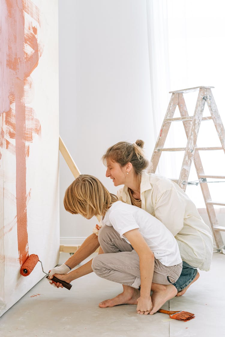 Mother And Son Painting The Wall