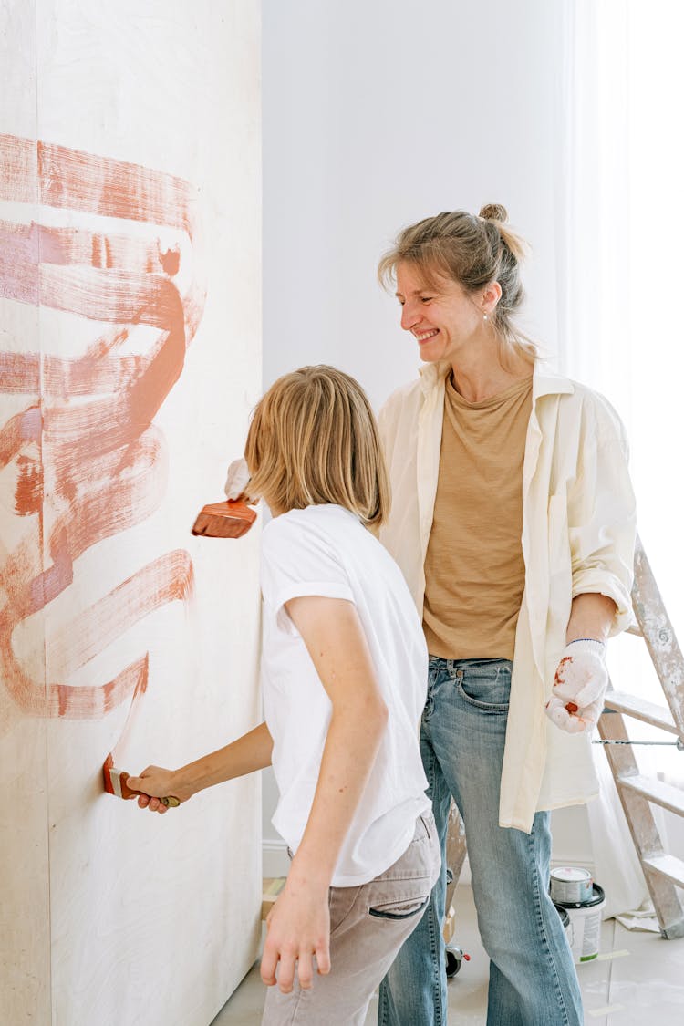 Mother And Son Painting The Wall