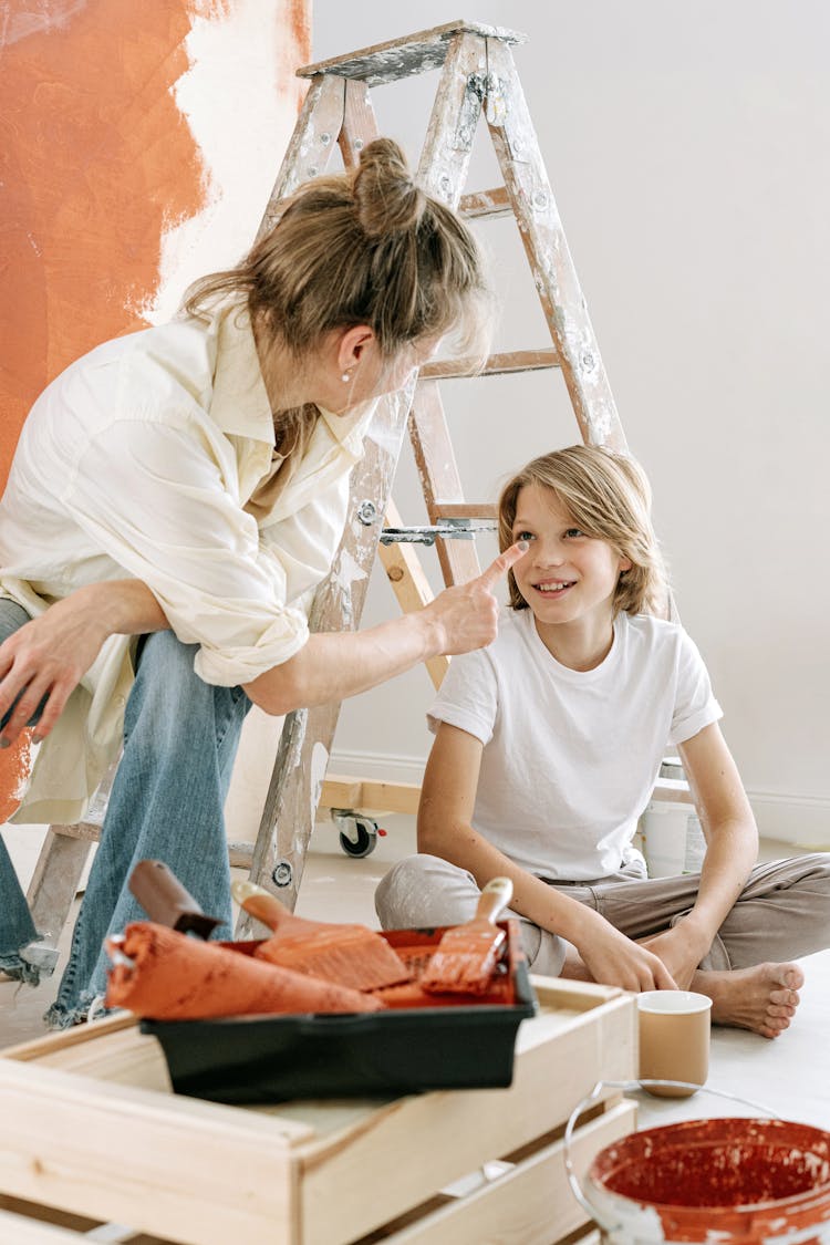 Mother And Son Renovating A Room 