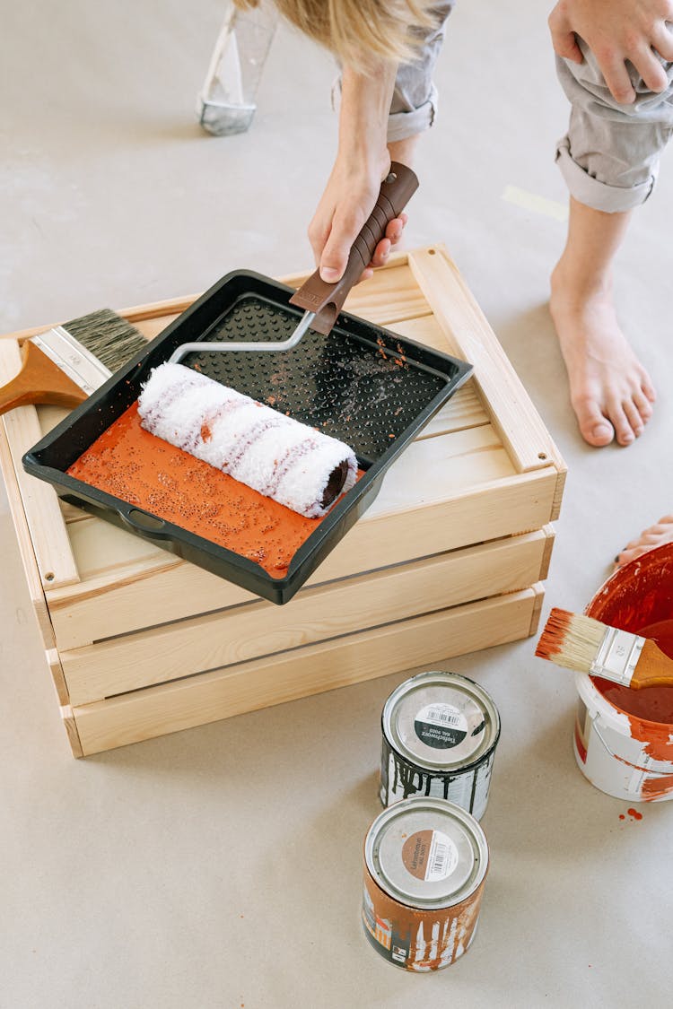 A Person Holding A Paint Roller