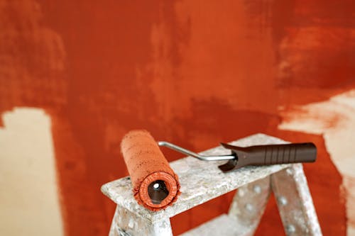Free Paint Roller With Brown Paint On A Stepladder Stock Photo