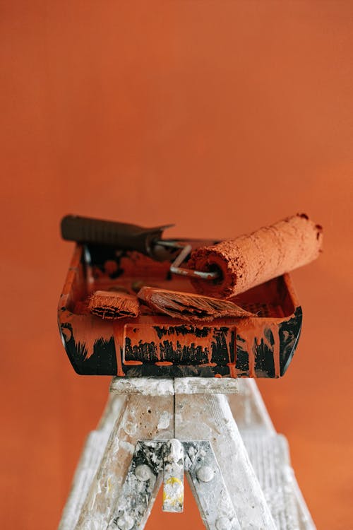 A Tray With Dirty Paint Brushes and Roller  On a Stepladder