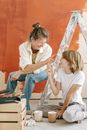 Mother and Son Having Fun with Paint on Their Finger