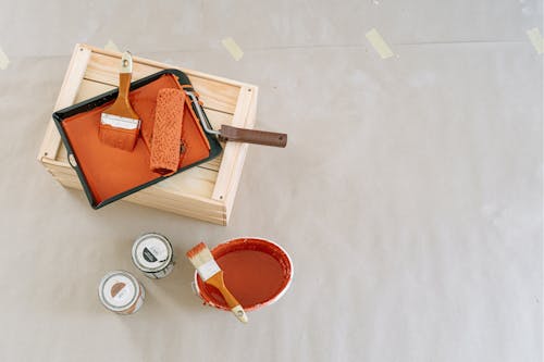 Free Painting Materials on Wooden Crate and Floor Stock Photo