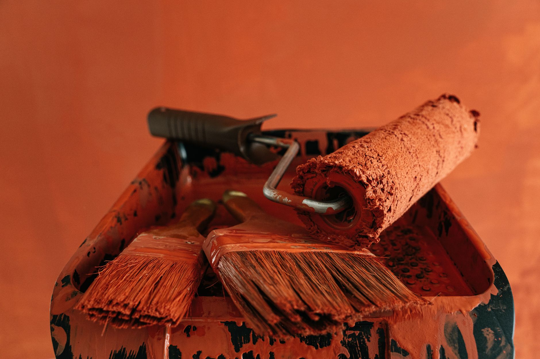 Cleaning Up After DIY Projects with Home Depot Products: A Practical Guide Orange paint tools in a messy tray, perfect for renovation themes