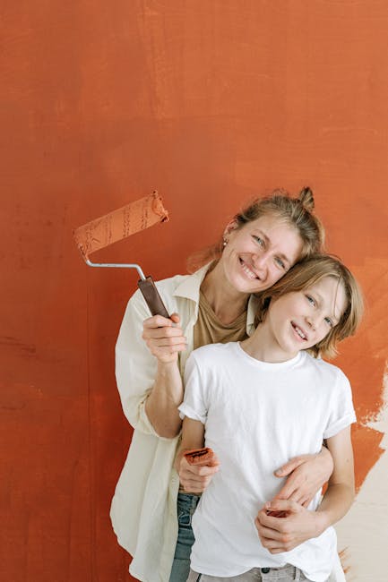 Parents and teen smiling while repainting a bedroom together.. A moment pictured by Ivan Samkov