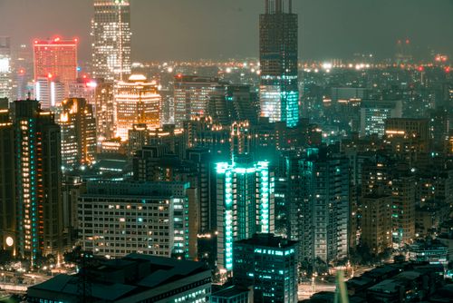 Free Illuminated urban skyline featuring modern skyscrapers and city lights at night. Stock Photo