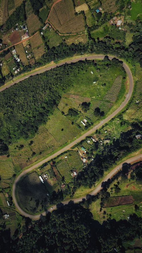 Free Stunning aerial view of Iten countryside in Kenya, showcasing winding roads and lush vegetation. Stock Photo