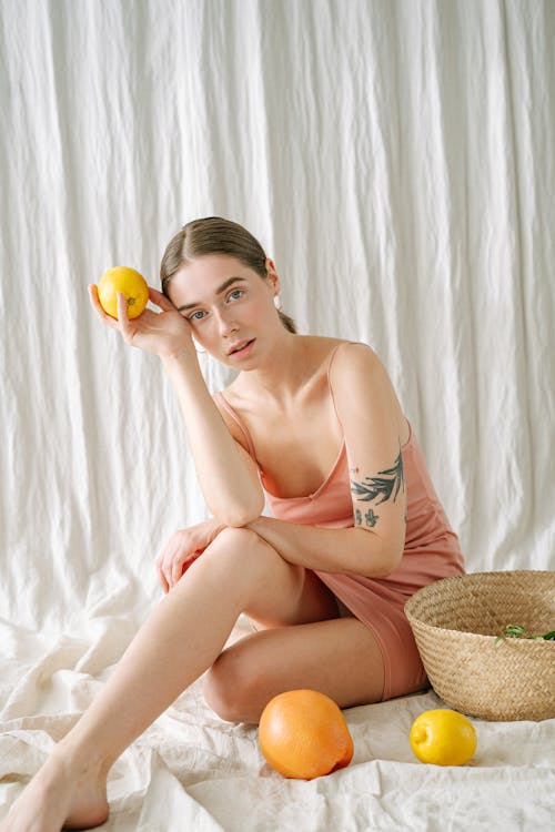 A Woman Holding a Lemon 
