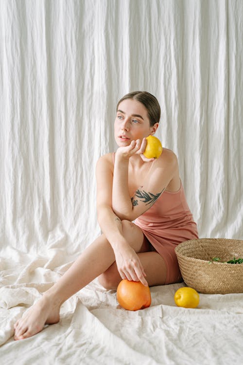 Free A Woman Holding a Lemon  Stock Photo