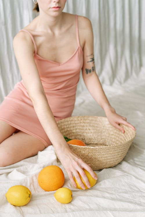 Free A Person Holding a Basket and a Lemon  Stock Photo