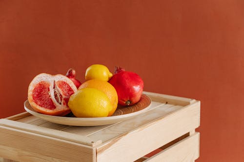 Free Yellow Citrus Fruit and Red Apple Fruit on Brown Wooden Tray Stock Photo