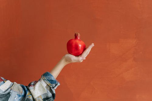 A Person Holding a Pomegranate Fruit