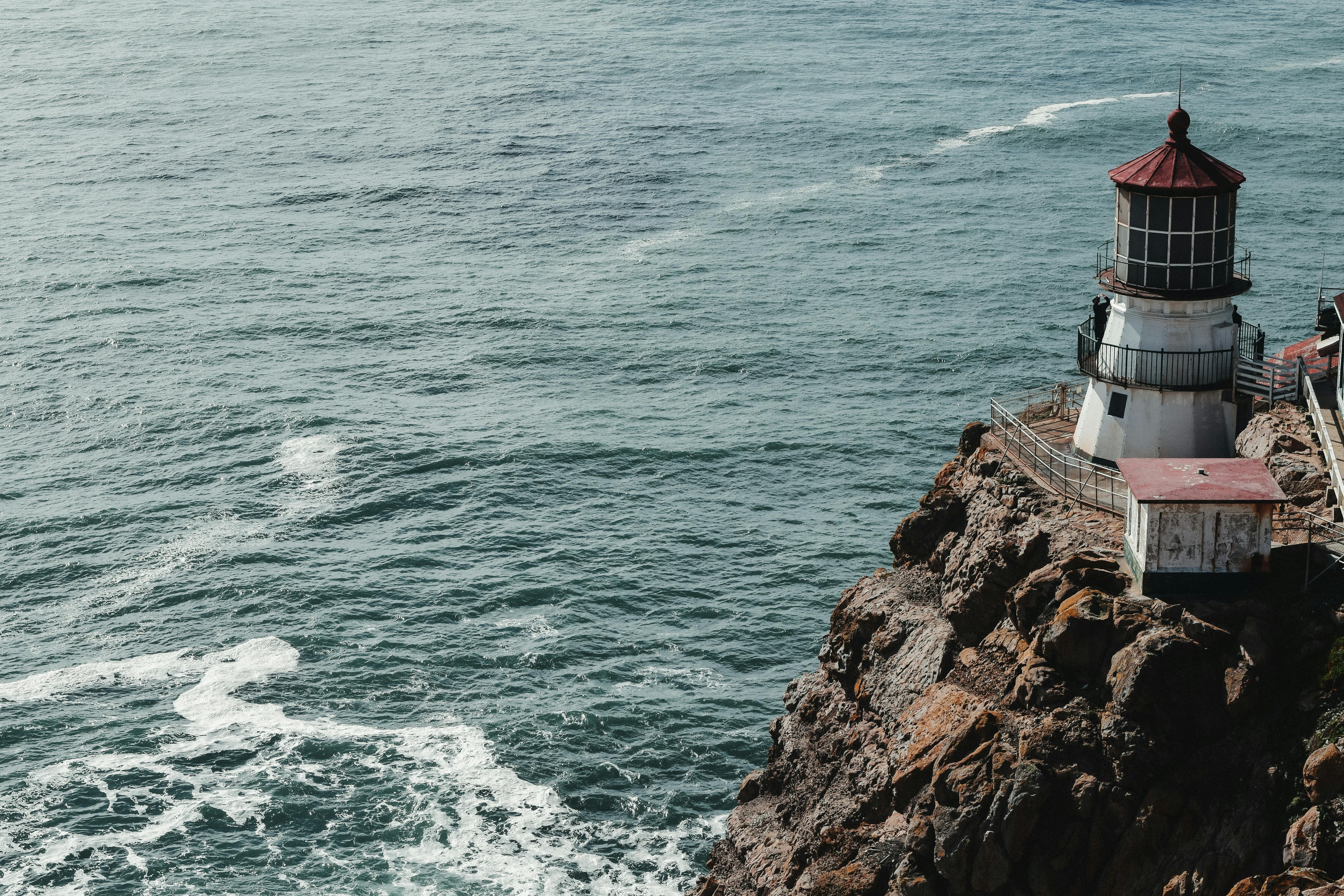 lonely lighthouse on high cliff above ocean