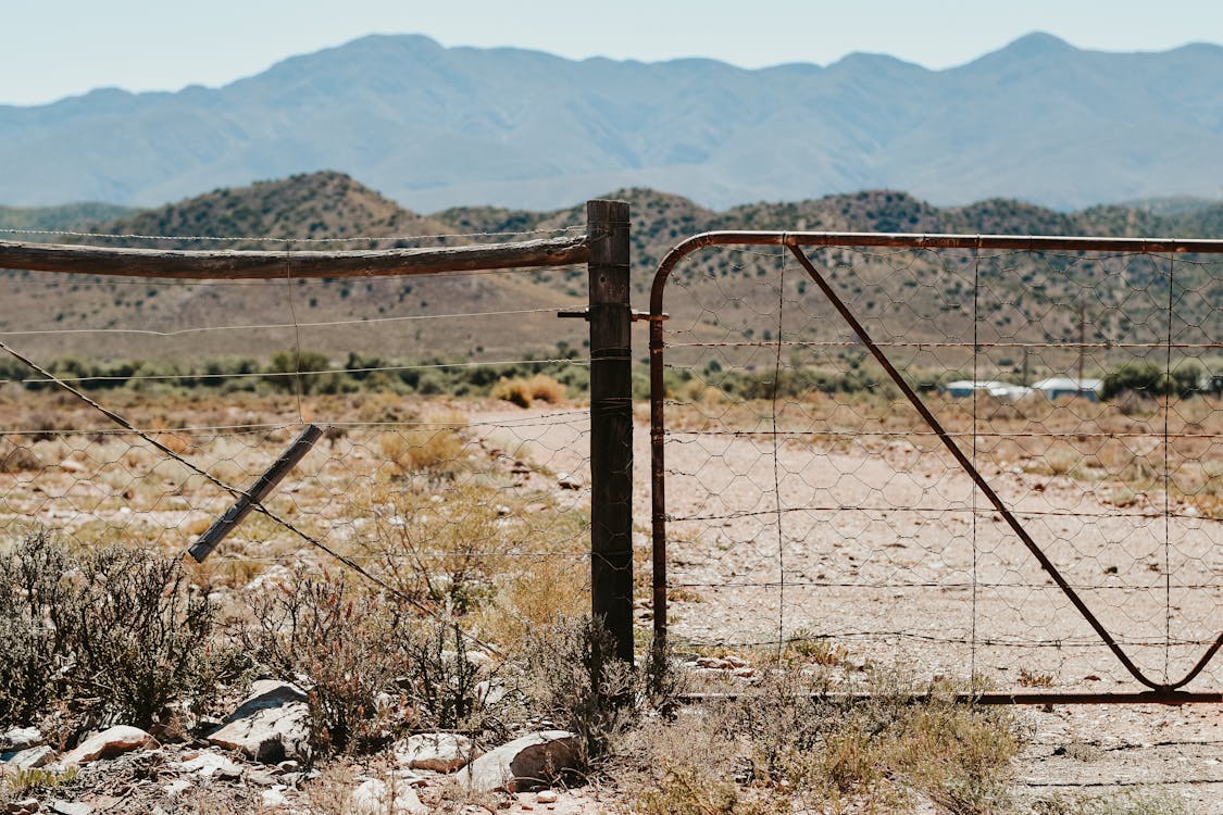 Fenced barrier in dry remote terrain