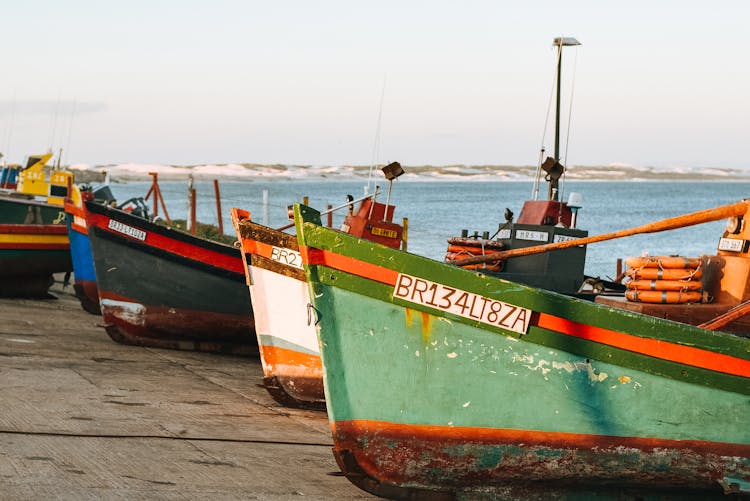 Old Fishing Boat Moored On Asphalt Dock