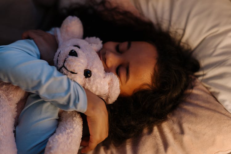 Girl Hugging White Bear Plush Toy