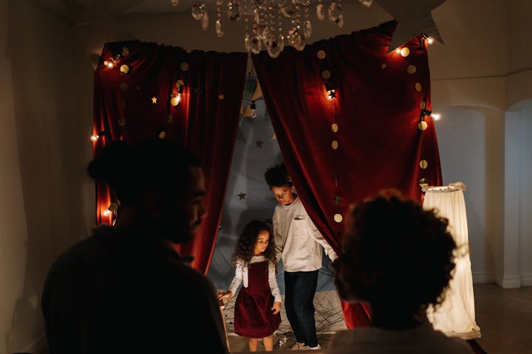 People Standing Near Red Curtain