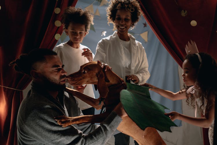 Father Of The Family Petting Their Dog 