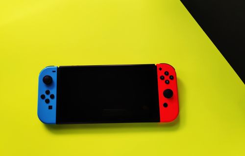 Free A handheld gaming console featured on a vibrant yellow background, showcasing gaming technology. Stock Photo